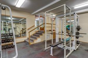 a gym with treadmills and a stairway at Bridges 25 in Sugarbush Village