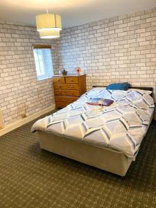 a bedroom with a large bed and a brick wall at Preston Stanley 1 Bed Flat 3a in Preston