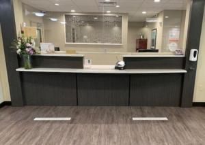 a lobby with a reception counter with flowers on it at Candlewood Suites - Austin North by IHG in Austin