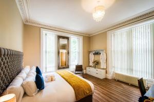 a bedroom with a large bed and a large window at Rosedene Highland House Apartments, Central Inverness in Inverness