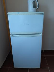 a refrigerator with a blue light on top of it at Apartment on Lermontova 35a in Mukacheve
