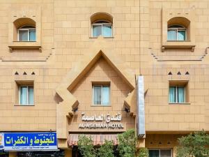 a building with a triangle on the side of it at Al Asemah Hotel in Riyadh