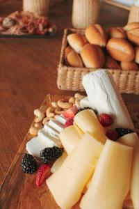 a bunch of cheese and fruit on a wooden table at Hotel Fontan Reforma Centro Historico in Mexico City