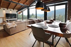 a living room with a table and a couch at Vila Pohoda in Donovaly