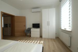 TV a/nebo společenská místnost v ubytování Modern Home Check-in & chill down auf 65 qm²