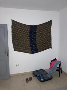 a flag hanging on a wall with a suitcase on the floor at New cozy flat with pool in amazing place..! in Costa Del Silencio