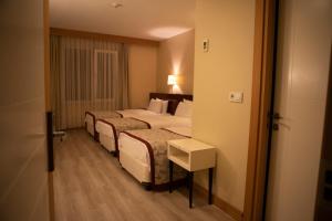Postel nebo postele na pokoji v ubytování Trakya City Hotel