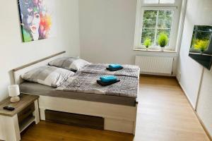 a bedroom with a bed with two towels on it at FeWo Seestadt mit Balkon in Goslar