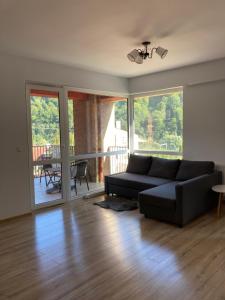 a living room with a couch and a table at Vita Bella Sinaia in Sinaia