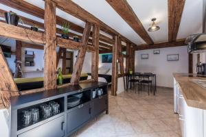 a kitchen with wooden ceilings and a dining room at Gite See You Soon - Studio Zen in Colmar