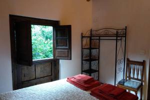 Postel nebo postele na pokoji v ubytování Casa rural en Asturias a orillas del río Narcea puerta de Somiedo
