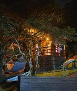 a house with two hammocks in front of it at Pousada Farol do Arvoredo in Governador Celso Ramos