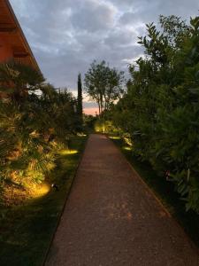 a walking path with trees and lights on it at Santa Lucia Maccarese - Residenza Agricola in Maccarese