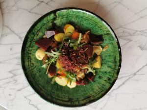 a green plate of food on a white counter at Santa Lucia Maccarese - Residenza Agricola in Maccarese