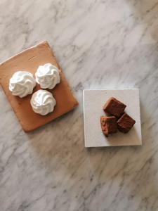 two pieces of brownies and whipped cream on a table at Santa Lucia Maccarese - Residenza Agricola in Maccarese