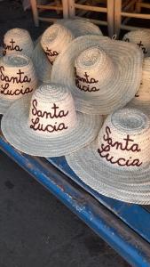a group of straw hats sitting on a table at Santa Lucia Maccarese - Residenza Agricola in Maccarese