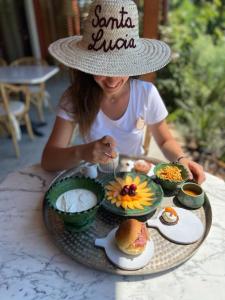 a little girl sitting at a table with a plate of food at Santa Lucia Maccarese - Residenza Agricola in Maccarese