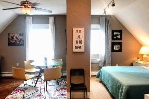 a bedroom with a bed and a table and chairs at Executive Suite Loft - Harvard Allston Campus in Boston