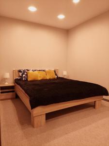 a bedroom with a large bed in a room at M14 Apartment in Gulbene