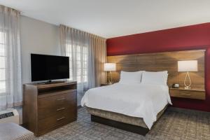 a hotel room with a bed and a flat screen tv at Staybridge Suites Anchorage, an IHG Hotel in Anchorage