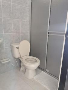 a bathroom with a toilet and a shower at hotel villa morenta in Yopal +18 photos