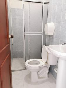 a bathroom with a toilet and a shower and a sink at hotel villa morenta in Yopal