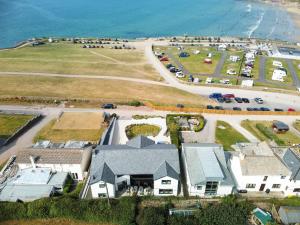 an aerial view of a house next to the beach at Megizzy in Polzeath