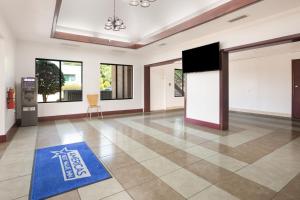 a living room with a blue rug on the floor at Americas Best Value Inn Stockbridge in Stockbridge