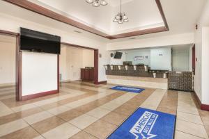 a lobby with a waiting room with a large screen at Americas Best Value Inn Stockbridge in Stockbridge