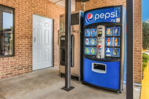 a pepsi machine in front of a brick building at Americas Best Value Inn Stockbridge in Stockbridge +3 photos