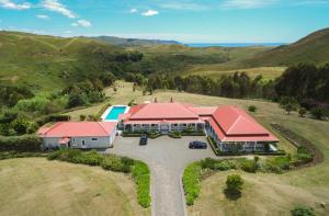 an aerial view of a house with red roofs at Cape South Estate - International award-winning country estate with Pacific views in Havelock North