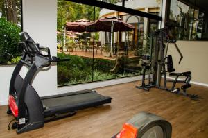 a gym with an exercise bike and an umbrella at Recanto Da Paz Hotel Fazenda in Atibaia