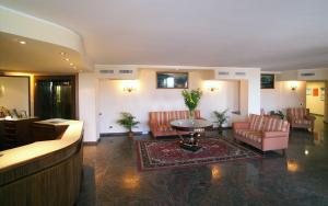 a lobby with couches and a table in a building at Hotel Villa Bianca Resort in Taormina