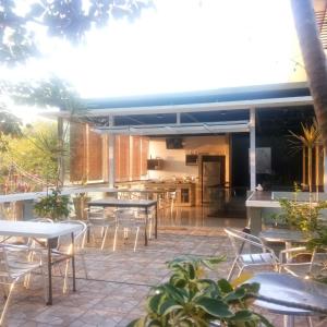 a patio with tables and chairs on a patio at White Rock Lodge in Nusa Dua