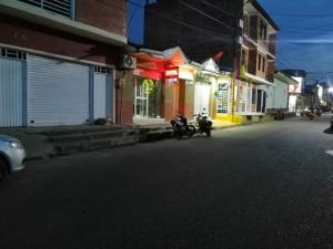 two motorcycles parked on the side of a street at night at Hosteria los Cristales in Santander de Quilichao