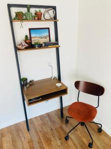 a desk and a chair next to a shelf at Death Valley Hot Springs 3 Bedroom in Tecopa