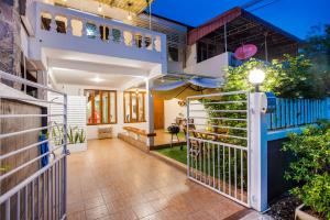 an external view of a house with a balcony at White beach house Hua hin 20 second to the beach in Hua Hin