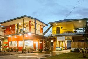 a house with an orange and yellow at RedDoorz at EM Pensiontel Butuan City in Butuan