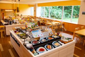 a buffet line with sushi and other food items at Kyukamura Shikotsuko in Chitose