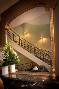 a staircase leading up to a balcony with a painting on it at Beau Monde International in Doncaster East