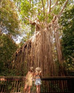 two girls standing in front of a tree at Coral Tree Inn in Cairns