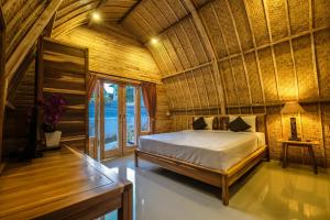 a bedroom with a bed in a bamboo room at Puri Sadewa Balangan in Jimbaran +37 photos