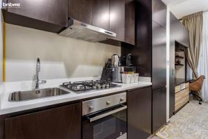 a kitchen with a sink and a stove at bnbmehomes - Apt In Business Bay - Heart of Dubai - 1820 in Dubai
