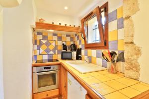 a small kitchen with a sink and a microwave at La Maison De Noelie - stunning house for rent in Le Bar-sur-Loup
