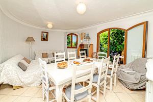 a dining room with a white table and chairs at Listed Accomodation 4 At 300m river 800m village and 30mn Nice Cannes Antibes in Le Bar-sur-Loup