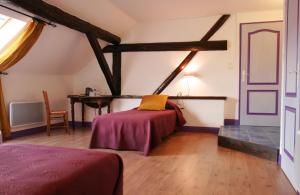 Tempat tidur dalam kamar di Le Clos des Pommes