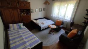 a small bedroom with two beds and a table at Smestaj Vanja in Arilje