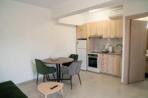 a kitchen with a table and chairs in a room at Hello Village Chania in SFakianalíon