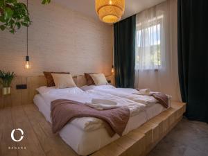 a large white bed in a room with a window at JUMBO APARTMENTS in Rajecké Teplice