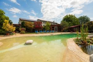 una piscina con sillas azules en un patio en Agriturismo L'Acero Rosso en Sacile